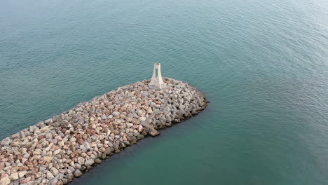 Aerial-flight-around-a-lighthouse-on-a-breakwater-France-drone-shot